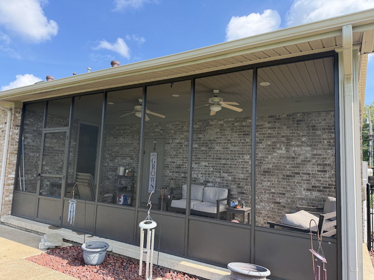 Screened porch with ceiling fans on a brick home