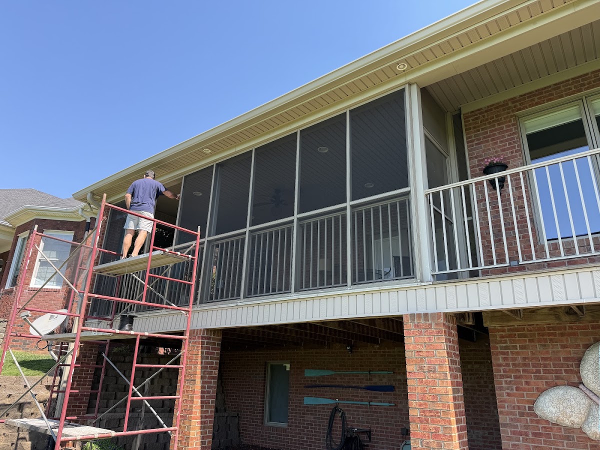 Screened porch being installed on a second-story deck