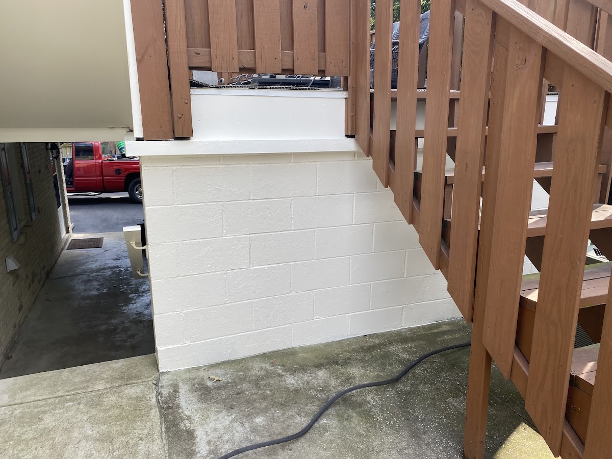 Painted block foundation under a wood staircase